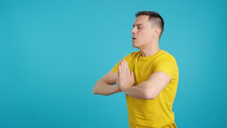 man in yellow shirt meditating