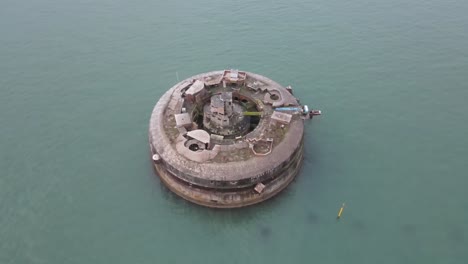 4k 30fps aerial drone flight around the derelict horse sand fort in the english channel showing a birdseye view of the smaller of three forts