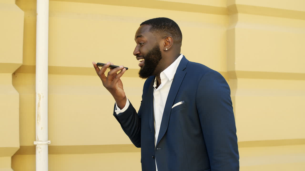 African american business having a phone call on speakerphone outdoors