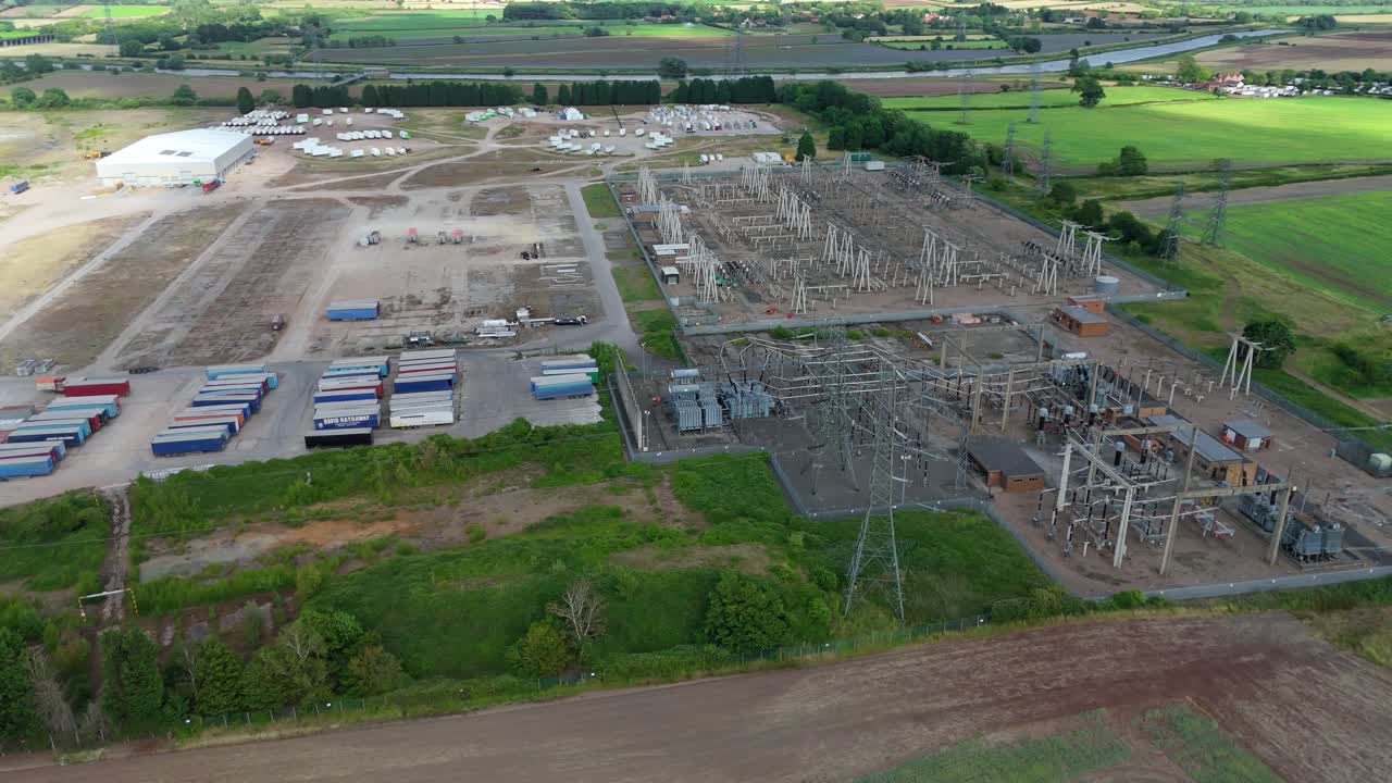 Aerial drone view of electrical substation and transformer station transferring energy in rural England