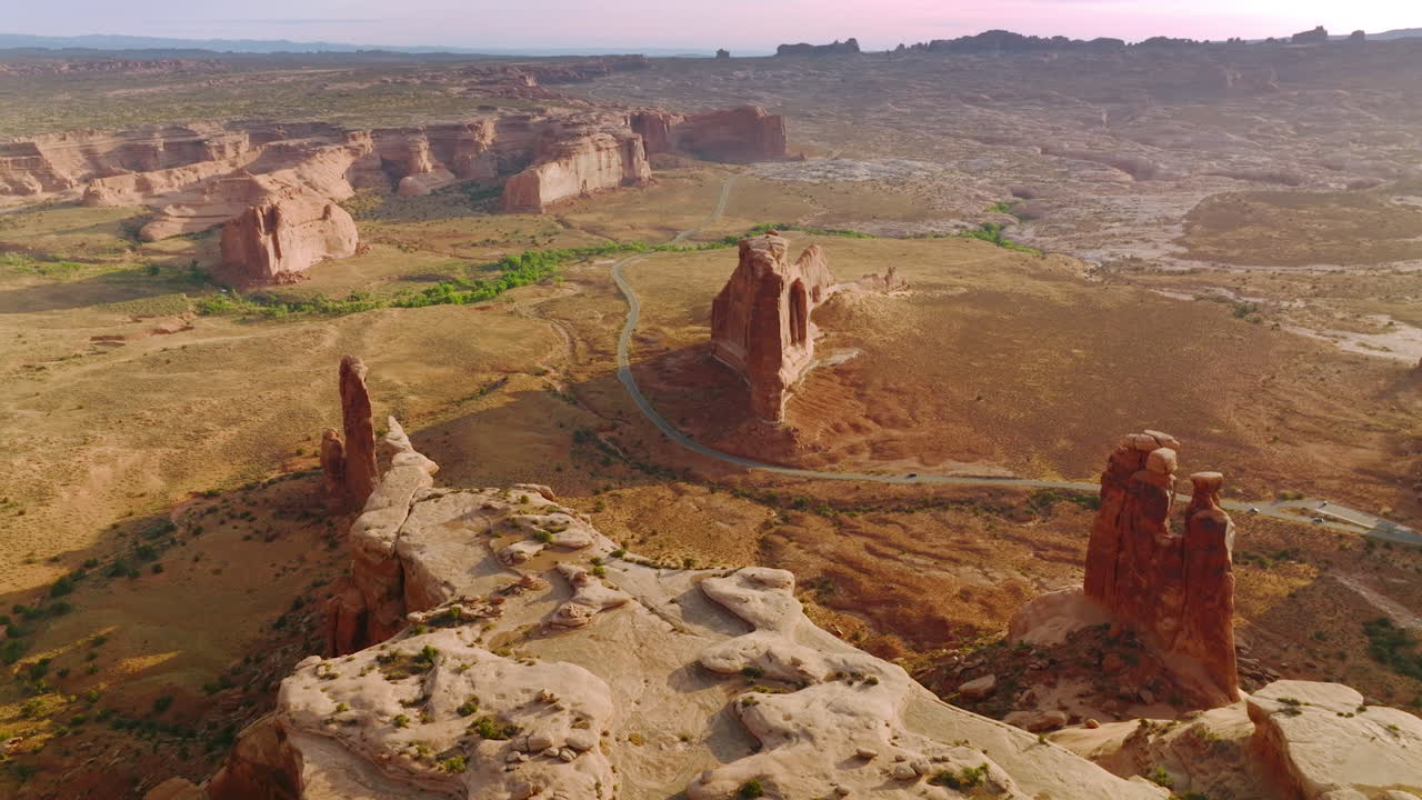 Diverse shapes of rocks in the dry desert of Utah, United States. Highway passing through the most interesting canyons in national park.