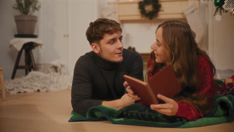 man talking with female friend holding book