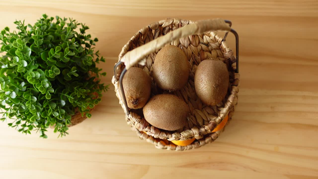 Kiwi and Orange Basket on Wooden Table