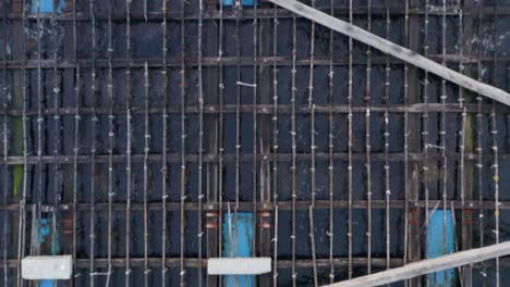 Simple-aquafarming-wooden-platform,-aerial,detail-closeup