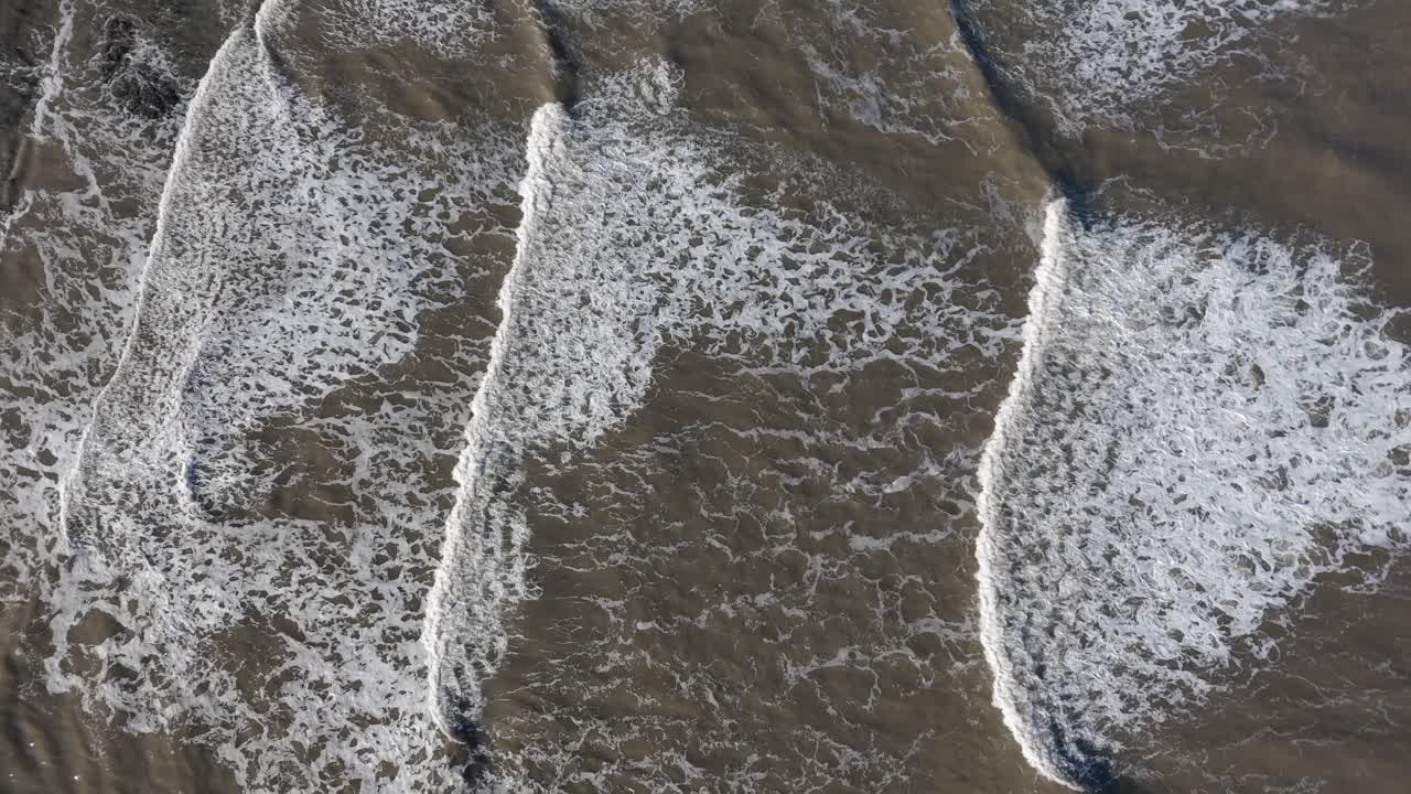 Aerial shot, bird eye view of waves crashing in the north sea off scarborough