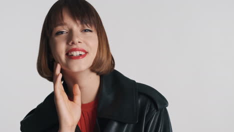 stylish model smiling on camera in studio