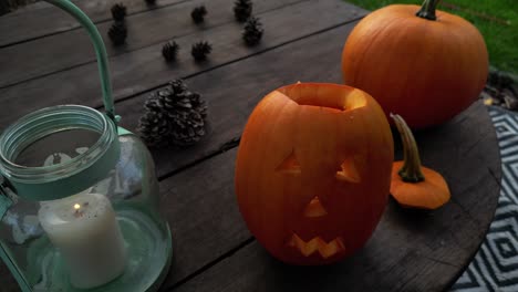 evening halloween preparation: dad lighting pumpkin lantern