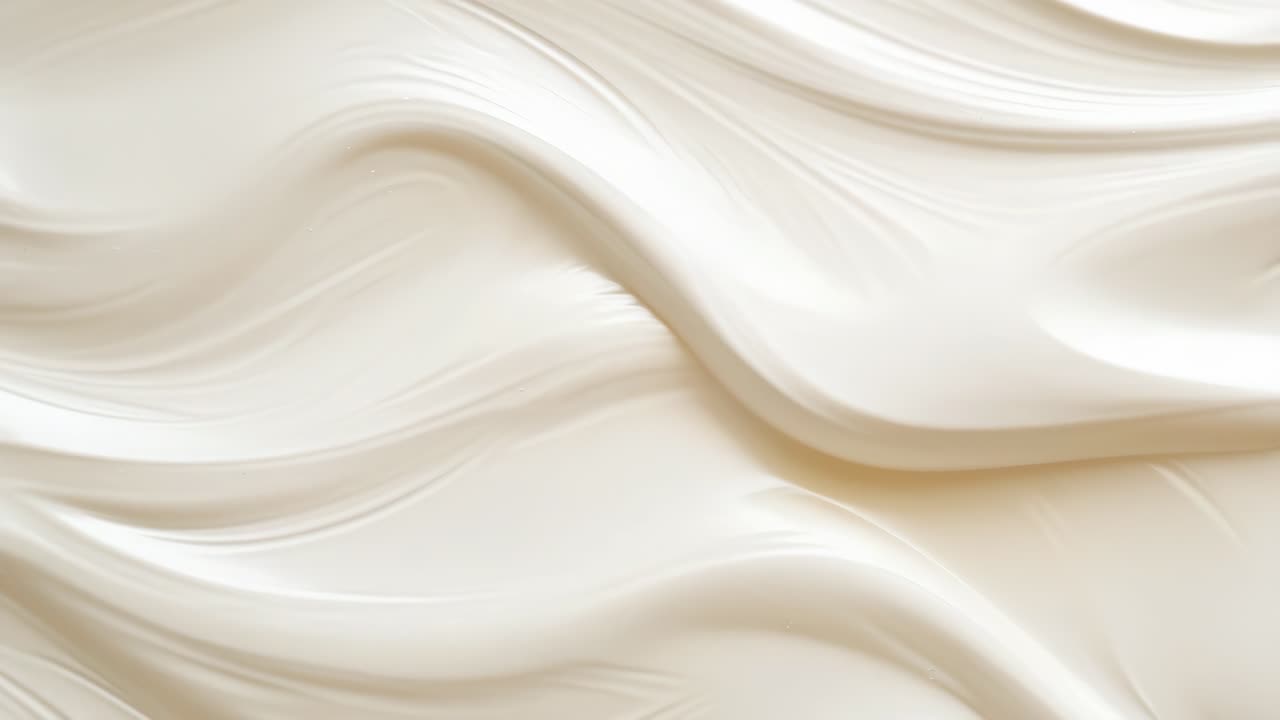 Abstract video background with a close-up angle of smooth, flowing cream-colored waves