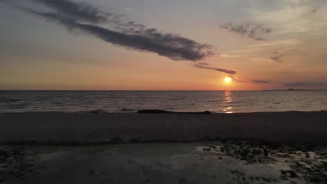 sunset over a tranquil beach with reflections