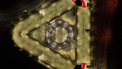 drone shot of multi story car park at night time