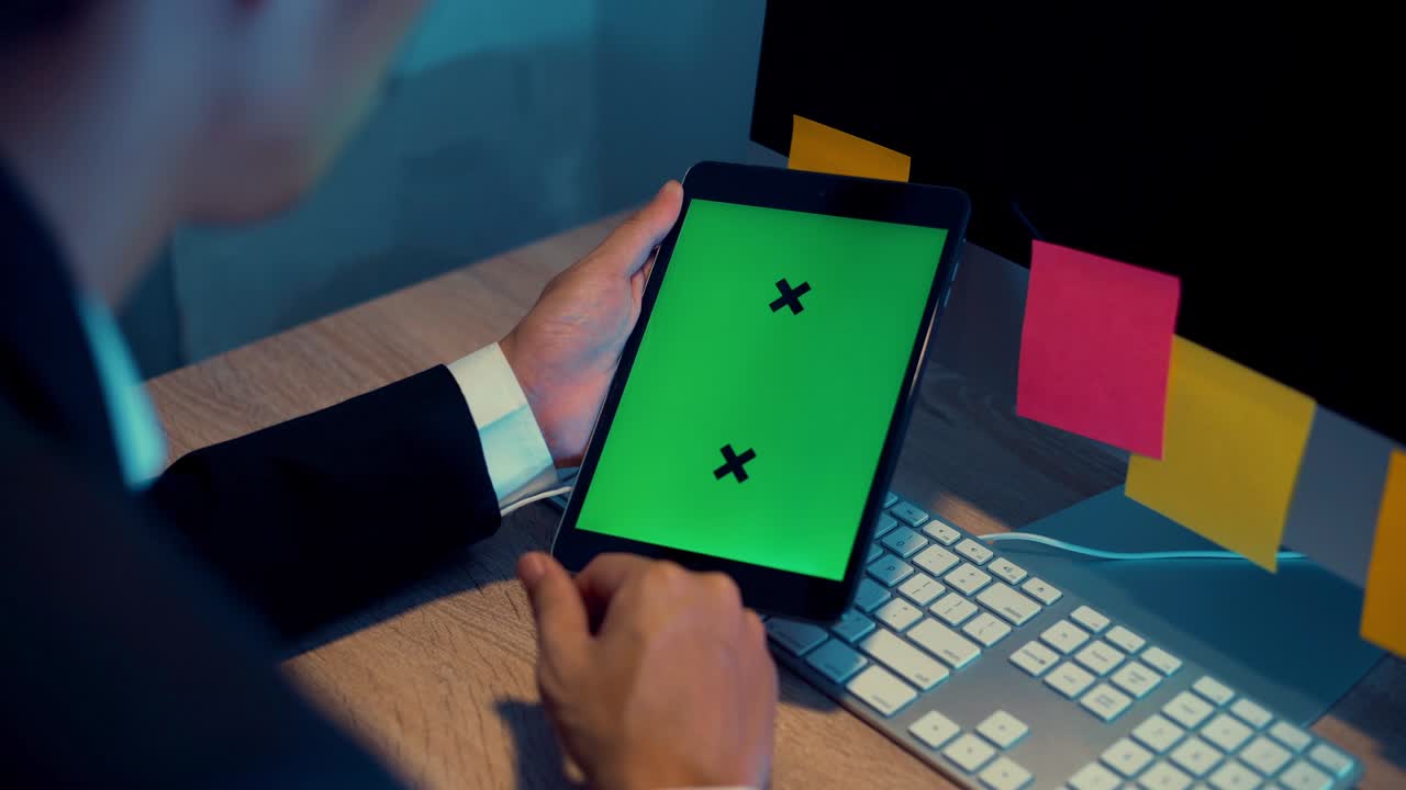 Business man looking tablet green screen