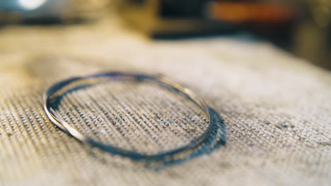 heating gold wire with burner flame in jewelry shop closeup