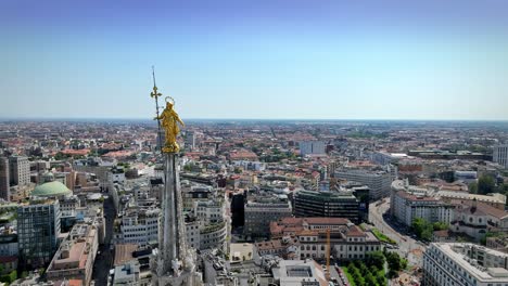 Drone-shooting-of-the-highest-statue-of-the-Cathedral-of-Milan,-the-"Madonnina"-and-of-the-whole-city-below