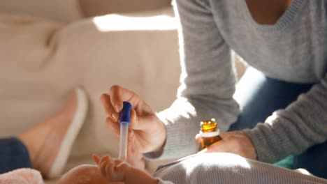 mother feeding medicine to her baby boy 4k