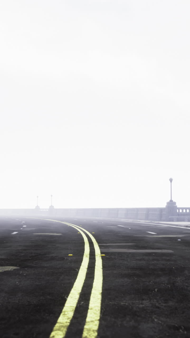 Lonely highway fading into fog silent street with faded yellow markings