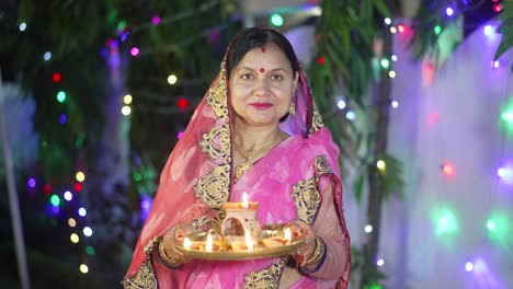 a women lighting a lamp