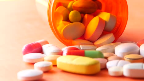 colorful pills and capsules spilled from an orange bottle