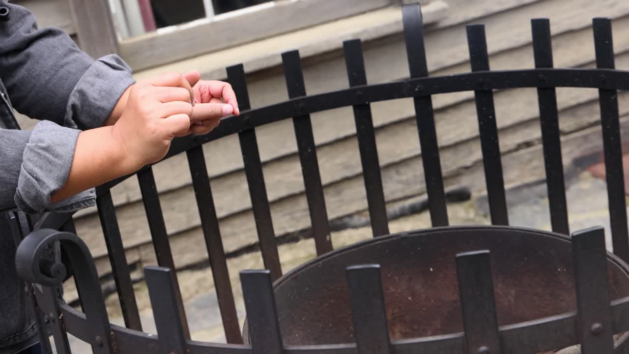 Hands warming over fire at outdoor