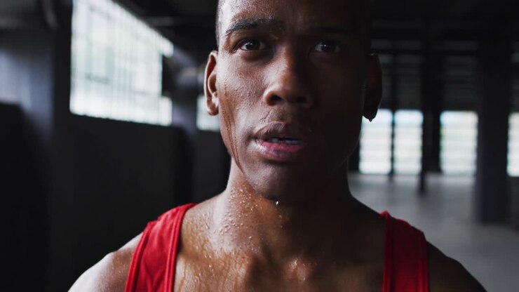 Portrait of african american man breathing heavily after a run in an empty building