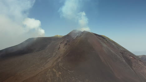 Mount-Etna-drone-shot-with-smoke-or-steam-coming-out-of-the-active-volcano-in-Sicily-Italy