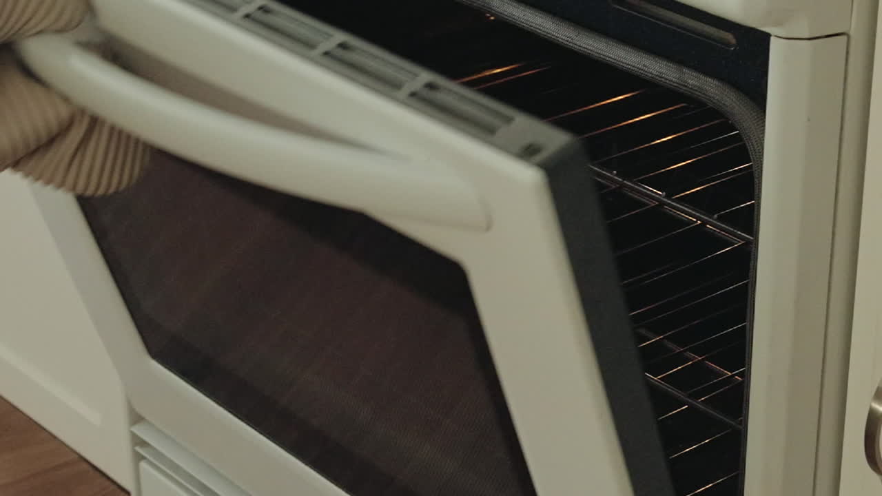 Opening oven door, placing pizza inside, preparing for baking