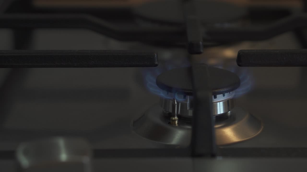 부에서 가스 스토브를 켜고, 가스 불꽃으로 비를 가열합니다. 근접, 4k 비디오.