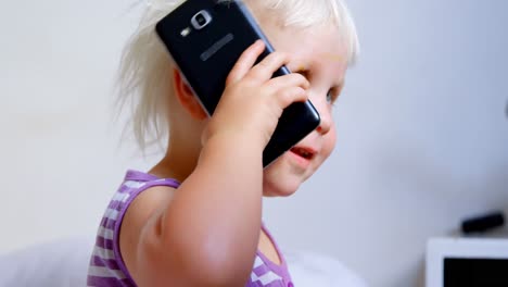 cute girl talking on mobile phone at home 4k