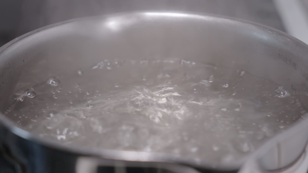 Slow motion footage of a pot with boiling water