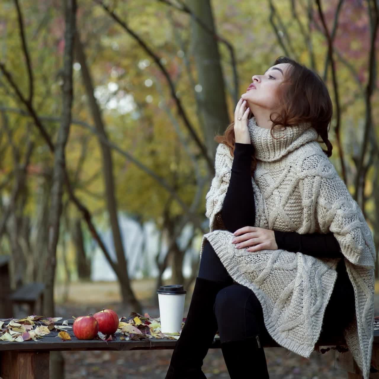 Woman with coffee in park