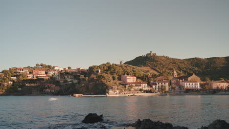 collioure coastal town, hillside buildings, distant castle view