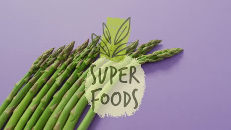 super foods text animation over asparagus on purple background