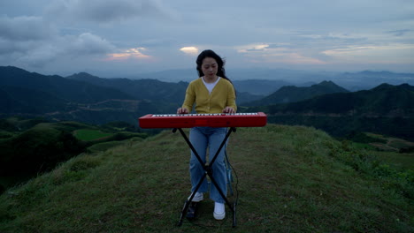 as the sun sets over the mountains, a young female artist shares her music with the world