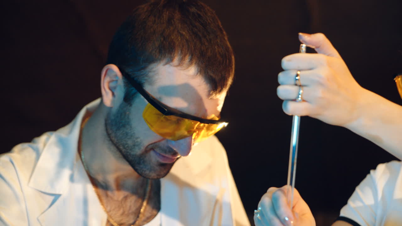 Two young scientists working together in research laboratory testing chemicals and bacteria. Concept of science