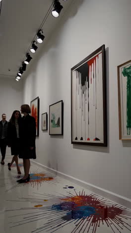 art gallery exhibition with abstract paintings