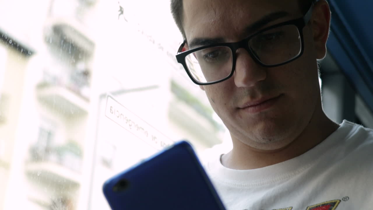 Man on bus using smartphone