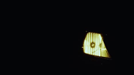 closeup of a modern car headlights on in smoke