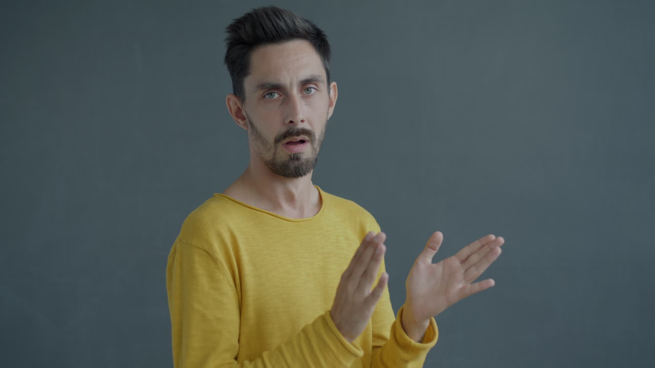 Man in a yellow shirt giving a presentation