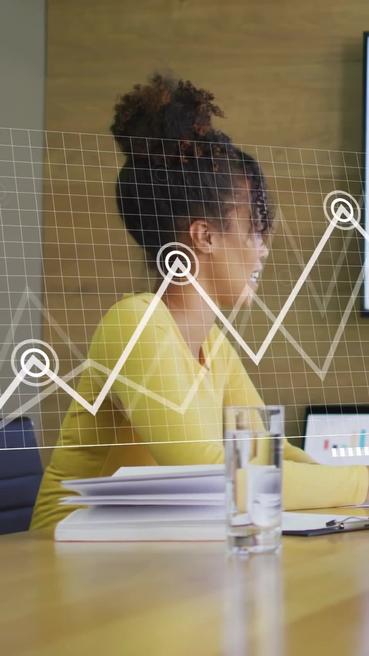 Vertical video: Woman leaning toward update, reviewing business charts animating from grid to bars