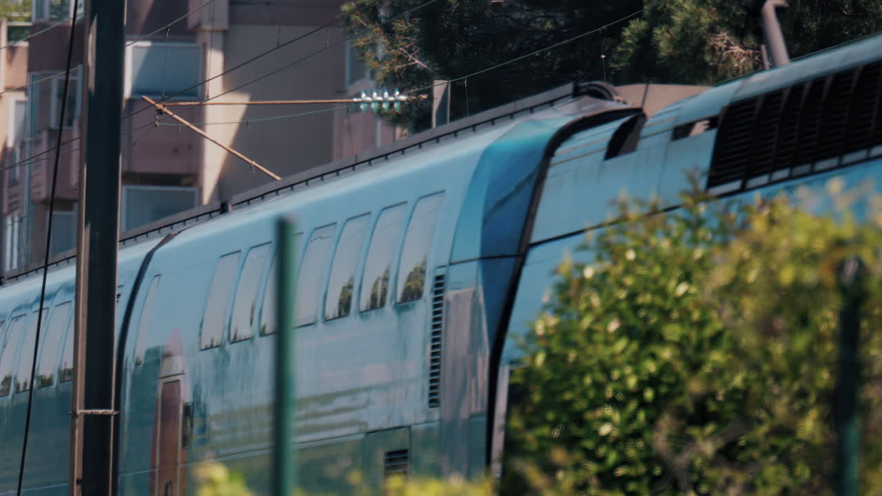 Blue train driving in Cannes, France, slow motion