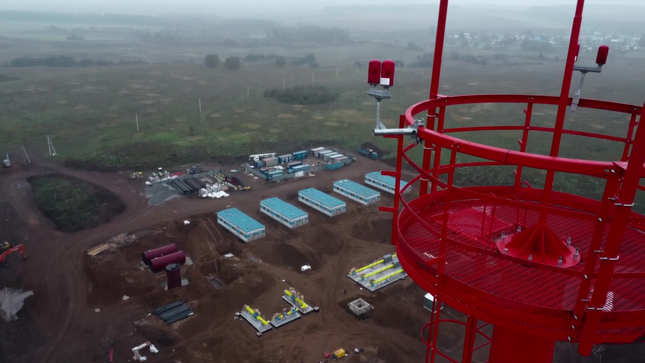 Aerial View of Red and White Communication Tower and Construction Site