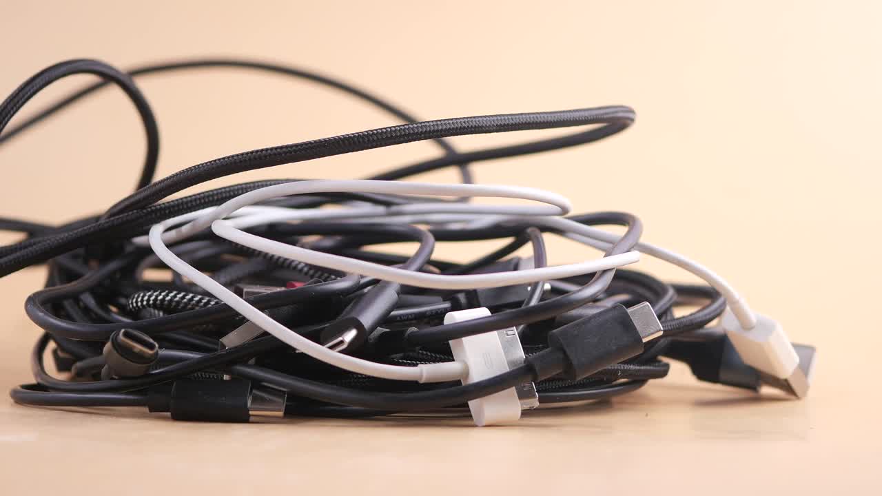 Pile of Tangled Charging Cables on a Table