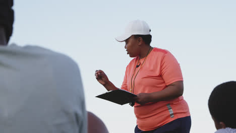 Female-rugby-coach-and-team-training