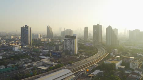 aerial view of highway street road at bangkok downtown skyline, thailand. financial district and business centers in smart urban city in asia.skyscraper and high-rise buildings at sunset