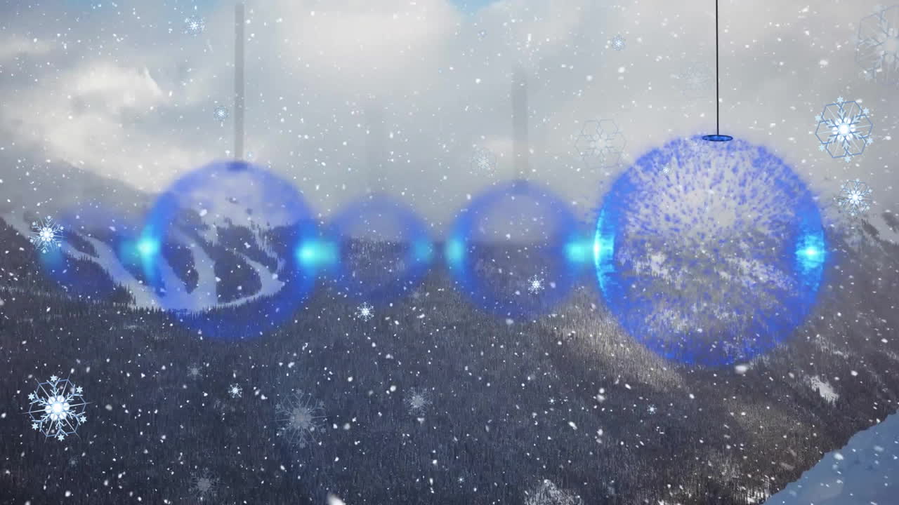 Animation of snow falling over mountains and christmas baubles
