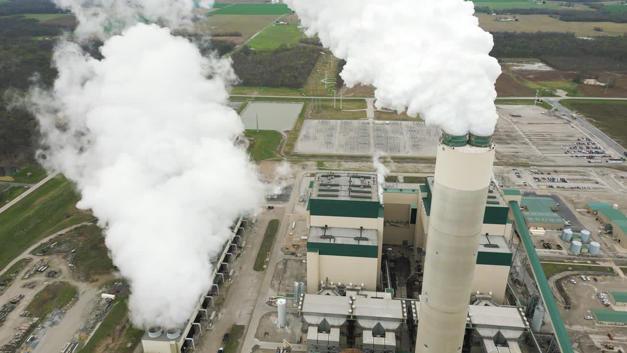 A large coal power plant in Illinois. The massive smoke stack can be seen billowing steam out of the top