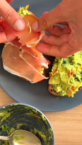 preparing avocado toast with prosciutto