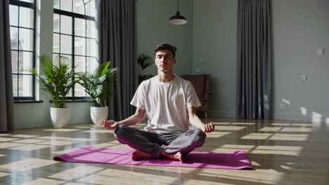 man meditating in a room