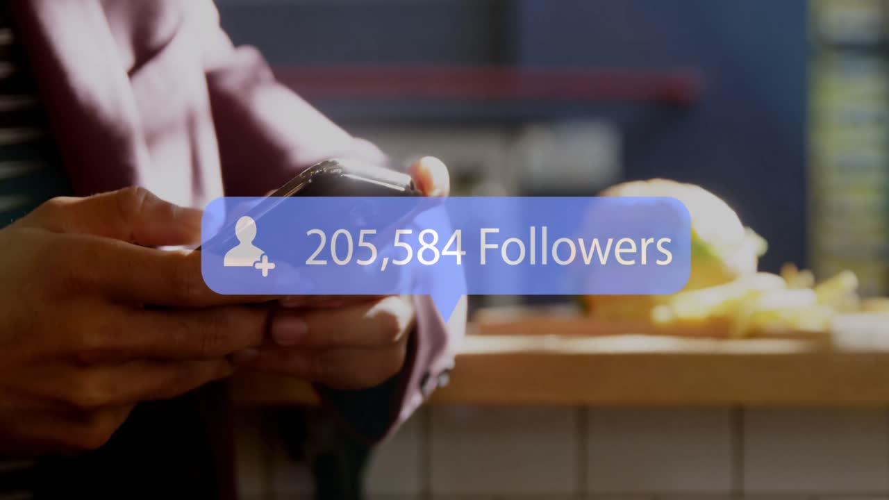 Animation of social media followers notification over hands of woman using smartphone at cafe