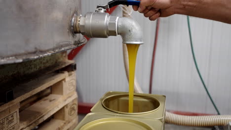 pouring honey in tin canister