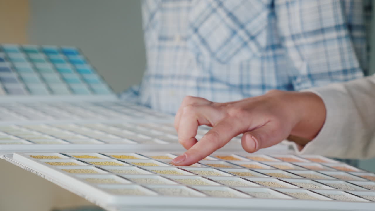 Customer Chooses Building Materials From An Image In A Catalog